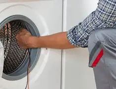 Dryer repair technician diagnosing and servicing a clothes dryer in Las Vegas, NV