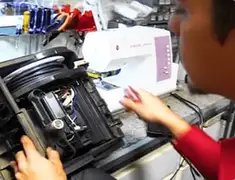 Vacuum repair technician servicing internal components on a workbench in Las Vegas, NV