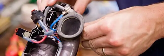 Vacuum repair technician reconnecting wiring and components in Las Vegas, NV