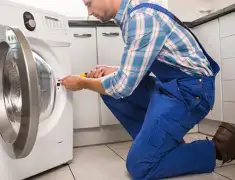 Washing machine repair technician servicing a front-load washer in Las Vegas, NV